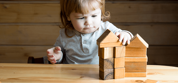 Dieťatko sa hrá s drevenými hračkami